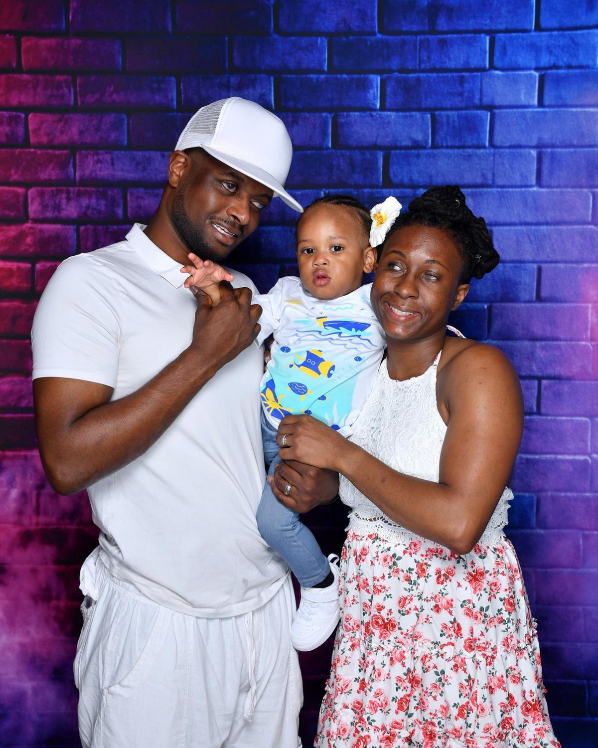 Kevin, Jasmine, and Elijah smiling together on their Royal Caribbean cruise in 2025.