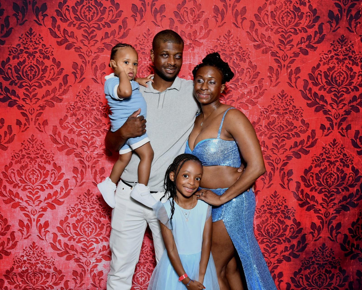 Kevin, Jasmine, Elijah, and Amari dressed up together on their Royal Caribbean cruise in 2025.