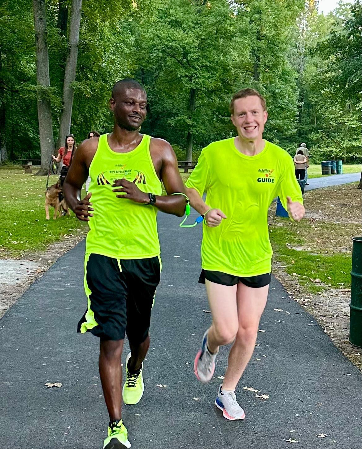 Kevin running tethered to his guide, Phil, at an Achilles weekly practice at Nomahegan Park in Cranford, New Jersey.